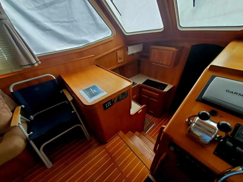 Slide: The Image of 2004 Sabreline 36 Flybridge Fast Trawler interior with wood finish and navigation equipment. - 19