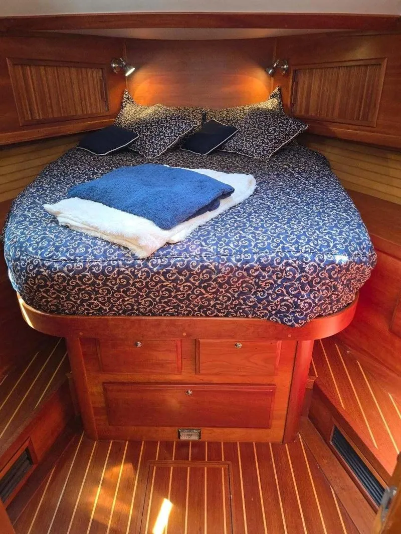 Slide: The Image of 2004 Sabreline 36 Flybridge Fast Trawler cabin with cozy bed and wooden interior. - 27
