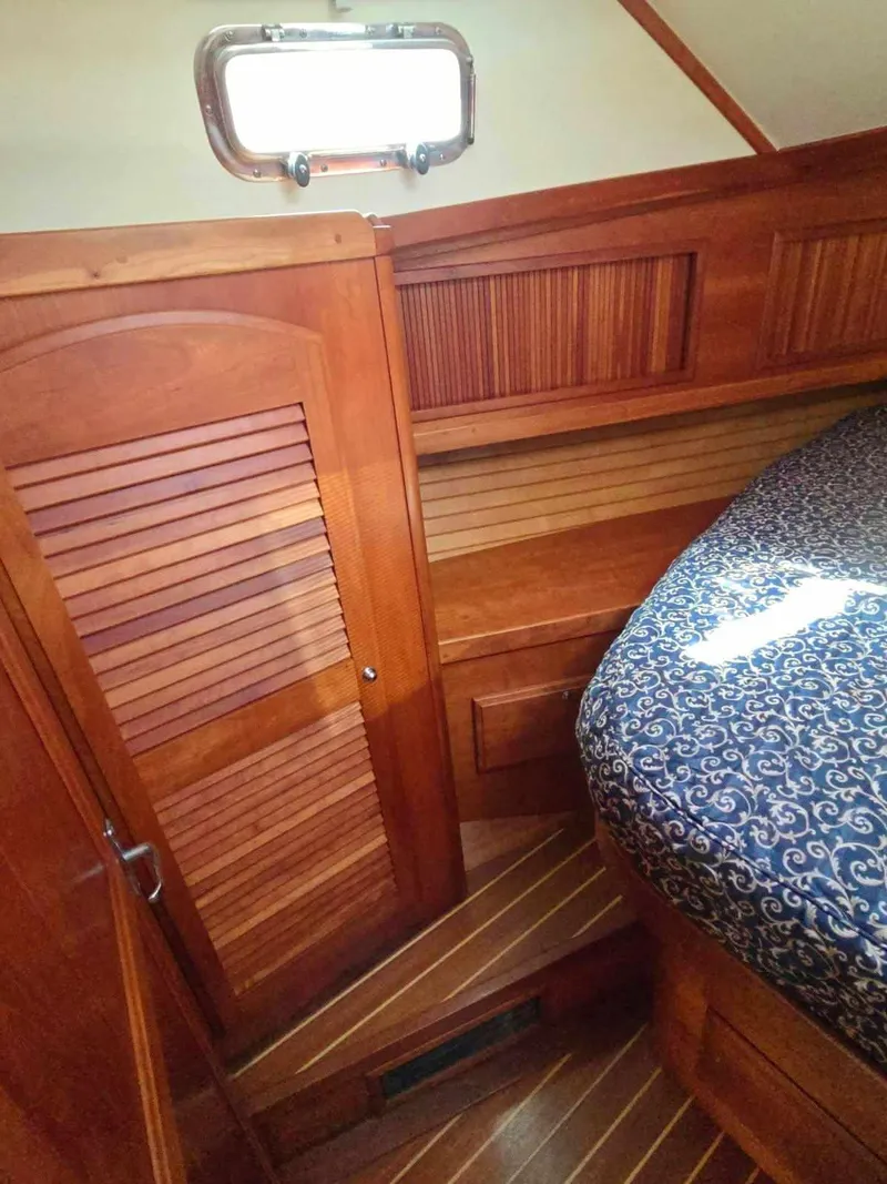 Slide: The Image of 2004 Sabreline 36 Flybridge Fast Trawler cabin with wooden interior and patterned bedding. - 28