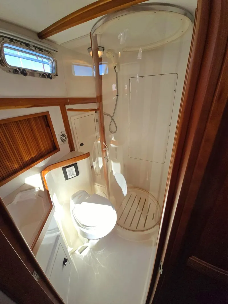 Slide: The Image of 2004 Sabreline 36 Flybridge Fast Trawler bathroom with shower and wooden accents. - 29