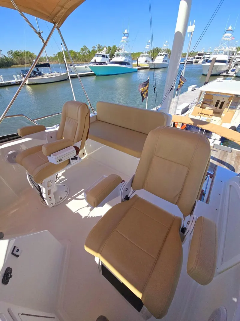 Slide: The Image of 2004 Sabreline 36 Flybridge Fast Trawler with beige seating at marina. - 39