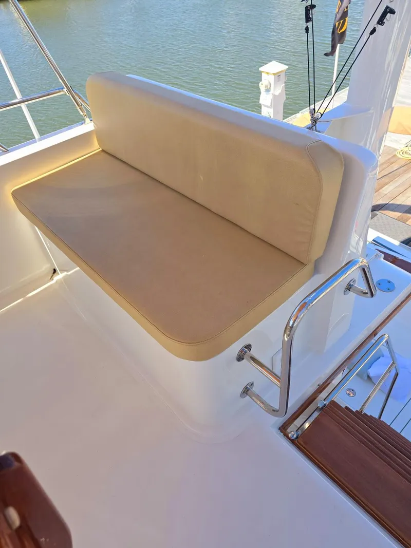 Slide: The Image of 2004 Sabreline 36 Flybridge Fast Trawler with cushioned seating on deck. - 41