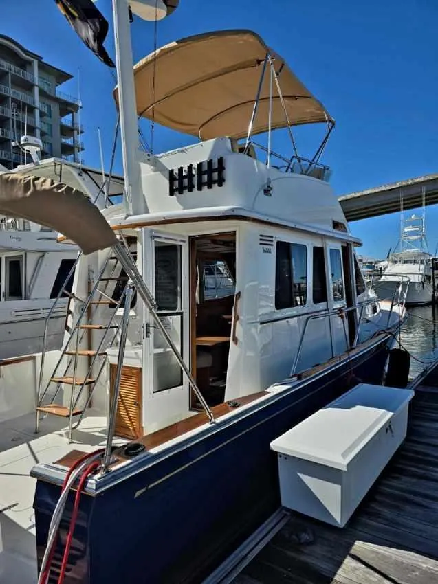 Slide: The Image of 2004 Sabreline 36 Flybridge Fast Trawler docked, featuring a spacious flybridge and classic design. - 8