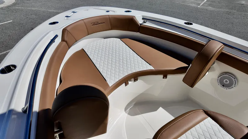 Slide: The Image of 2025 Pioneer 202 Islander boat interior with brown and white cushioned seating. - 12