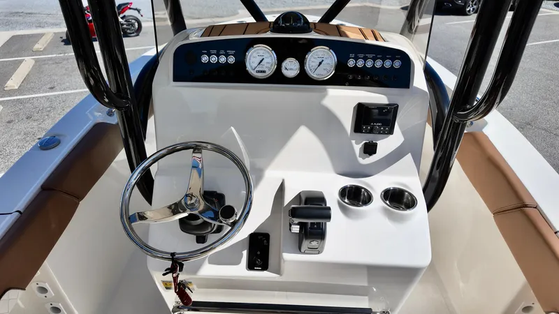 Slide: The Image of 2025 Pioneer 202 Islander boat dashboard with steering wheel and gauges. - 5