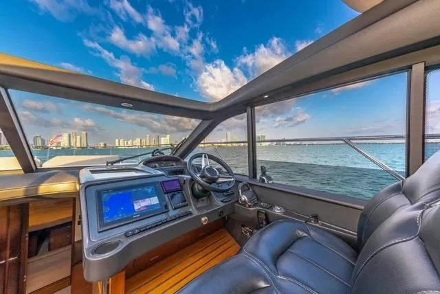 Slide: The Image of Interior view of 2017 Princess V48 Open yacht with city skyline and ocean. - 13