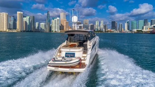 Slide: The Image of 2017 Princess V48 Open yacht cruising near city skyline. - 2