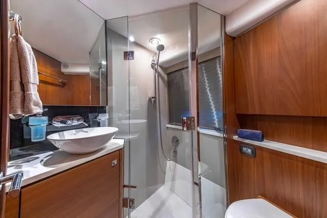 Slide: The Image of Luxurious bathroom in 2017 Princess V48 Open yacht with modern fixtures and wooden cabinetry. - 26