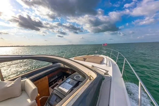 Slide: The Image of 2017 Princess V48 Open yacht cruising on open water under a partly cloudy sky. - 6