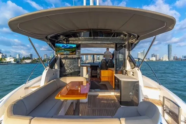 Slide: The Image of 2017 Princess V48 Open yacht with spacious deck, city skyline, and ocean view. - 11