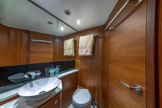 Slide: The Image of Luxurious bathroom in 2017 Princess V48 Open yacht with modern fixtures and wooden accents. - 25