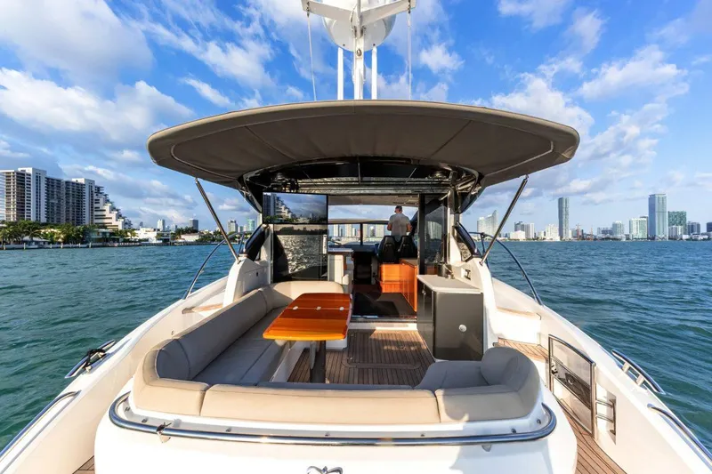 Slide: The Image of 2017 Princess V48 Open yacht on water with city skyline in background. - 7