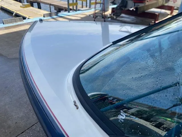 Slide: The Image of 1998 Malibu Response boat with water droplets on windshield, dockside view. - 14