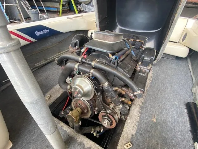 Slide: The Image of 1998 Malibu Response boat engine, exposed view, showcasing mechanical components and interior details. - 24
