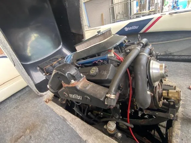 Slide: The Image of 1998 Malibu Response boat engine, detailed view with visible components and branding. - 26