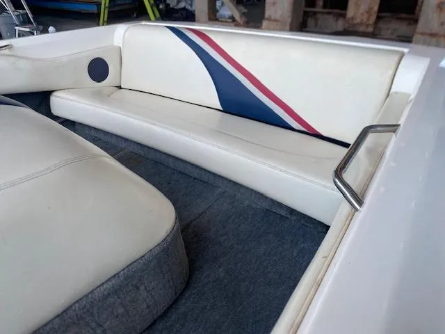 Slide: The Image of 1998 Malibu Response boat interior with white seating and blue-red accents. - 8
