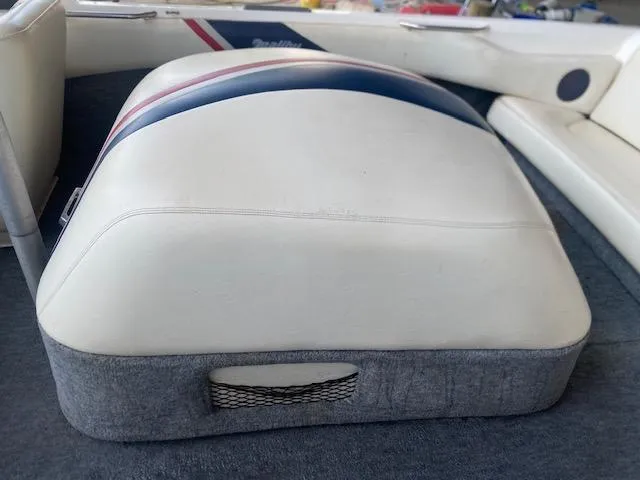 Slide: The Image of 1998 Malibu Response boat interior with white and blue cushioned seating. - 9