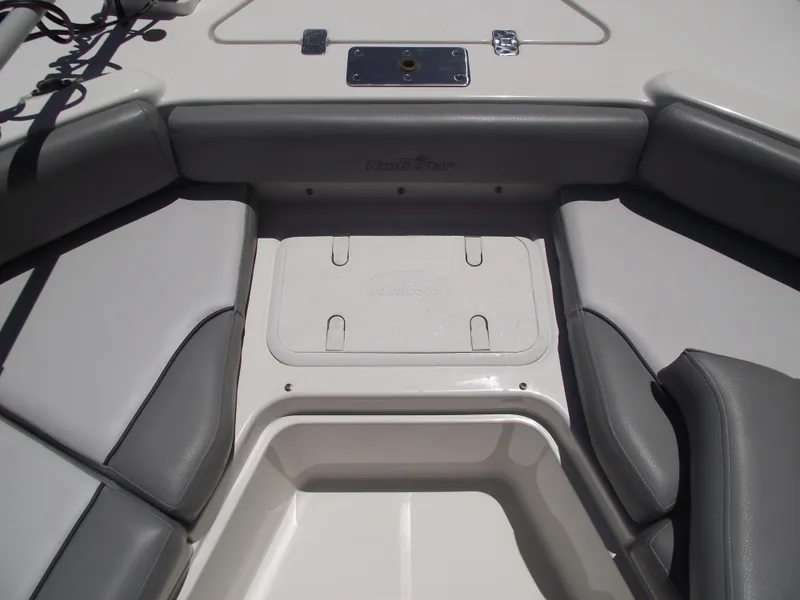 Slide: The Image of 2022 NauticStar 191 Hybrid boat interior with gray seating and storage compartment. - 12