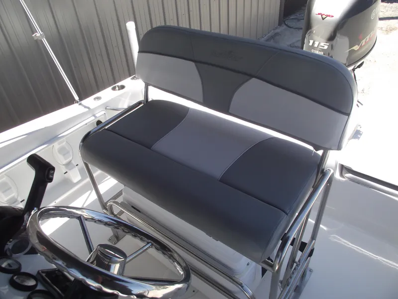 Slide: The Image of 2022 NauticStar 191 Hybrid boat interior with steering wheel and cushioned seating. - 20