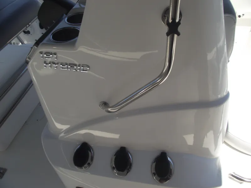 Slide: The Image of 2022 NauticStar 191 Hybrid boat console with cup holders and control knobs. - 23