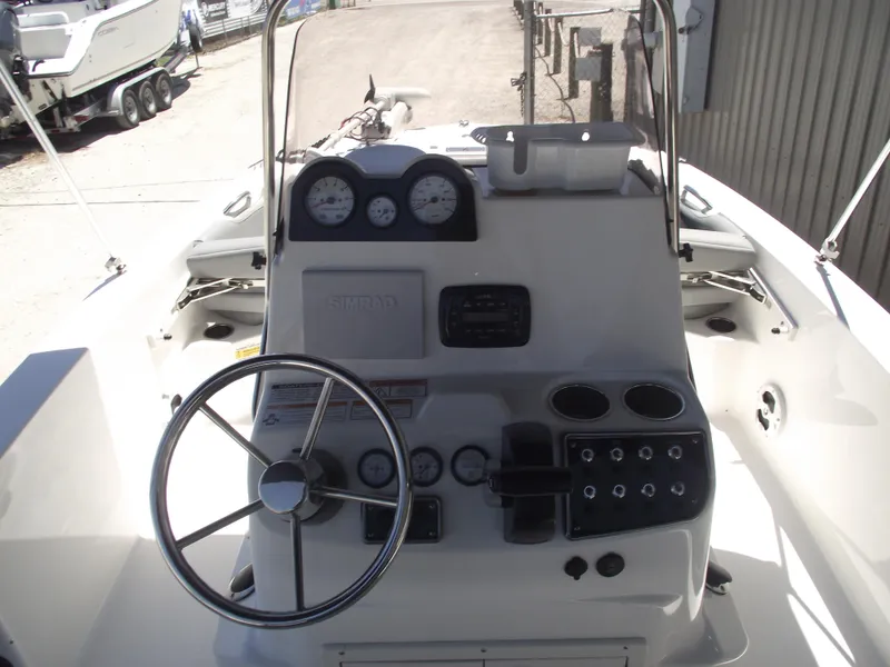 Slide: The Image of 2022 NauticStar 191 Hybrid boat dashboard with steering wheel and gauges. - 24