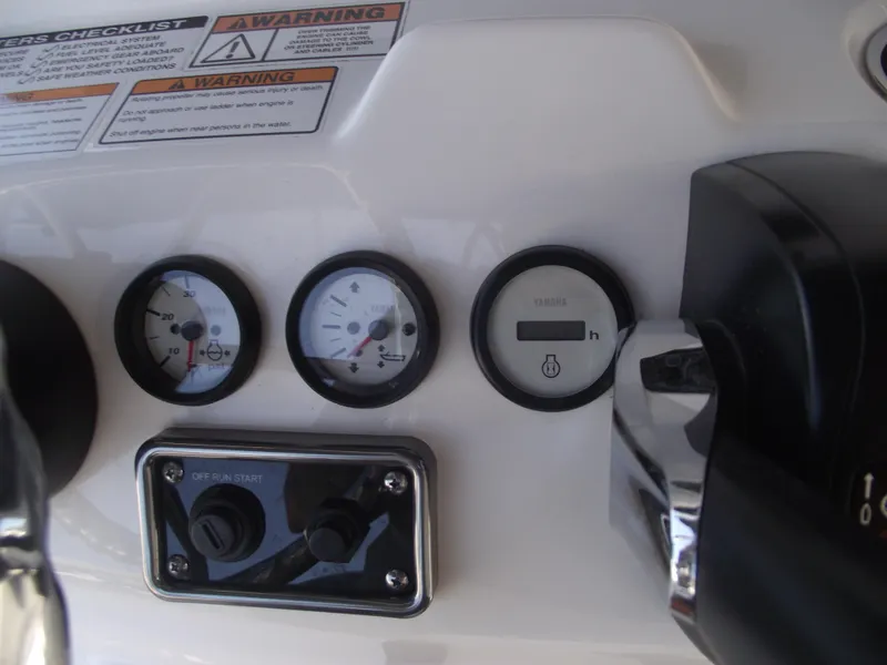 Slide: The Image of Dashboard of 2022 NauticStar 191 Hybrid boat with gauges and controls. - 26