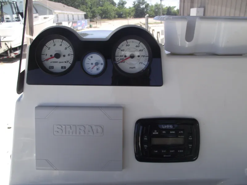 Slide: The Image of Dashboard of 2022 NauticStar 191 Hybrid boat with gauges and Simrad display. - 27