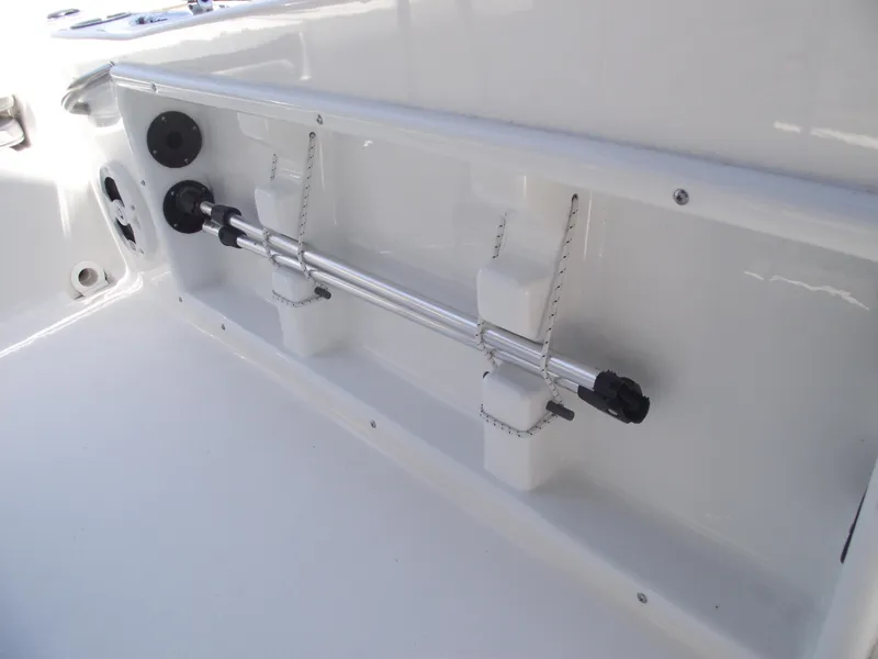 Slide: The Image of 2022 NauticStar 191 Hybrid boat interior detail with rod holders and storage. - 30