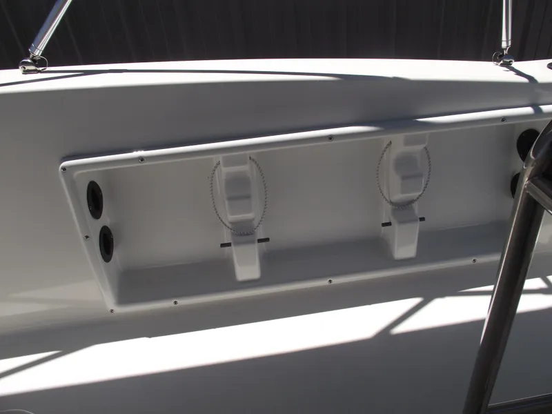 Slide: The Image of 2022 NauticStar 191 Hybrid boat interior with rod holders and storage compartment. - 31