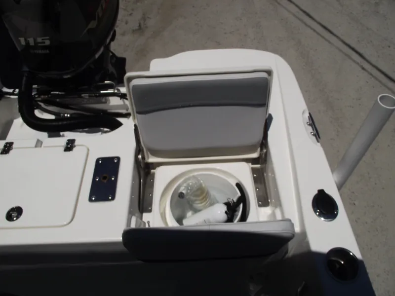 Slide: The Image of 2022 NauticStar 191 Hybrid boat with open storage compartment and visible engine. - 41