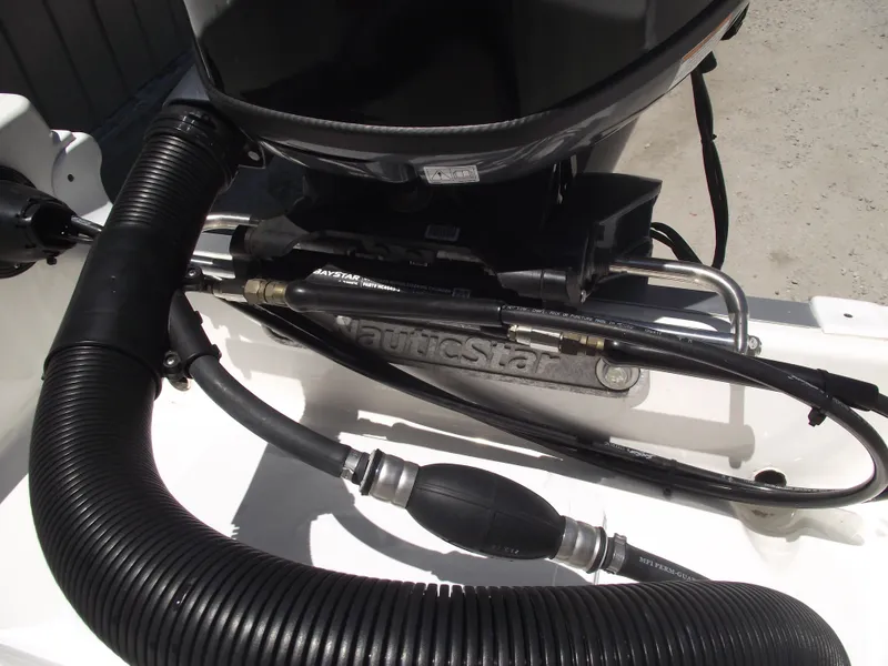 Slide: The Image of 2022 NauticStar 191 Hybrid boat engine components and hoses close-up. - 42
