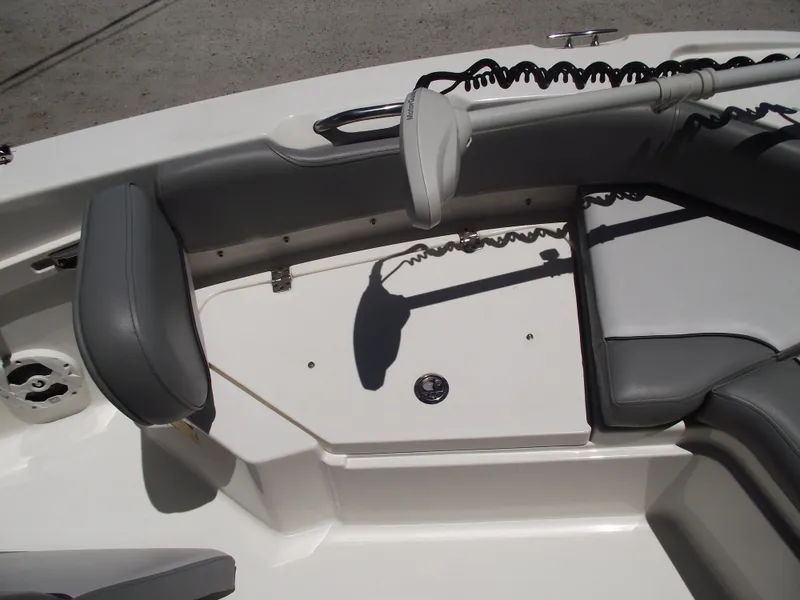 Slide: The Image of 2022 NauticStar 191 Hybrid boat interior with gray seating and storage area. - 9