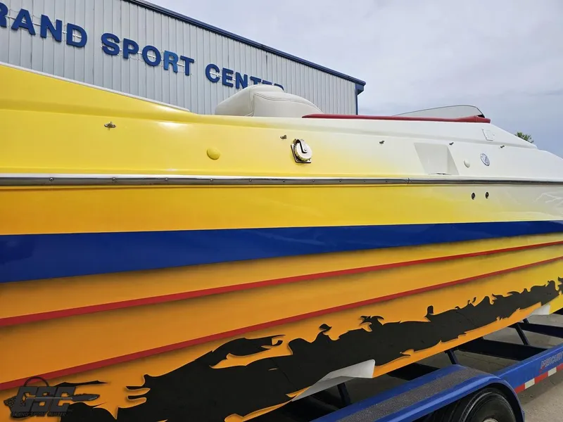 Slide: The Image of 2001 Cigarette 42 Tiger boat with vibrant yellow and blue design at Grand Sport Center. - 12