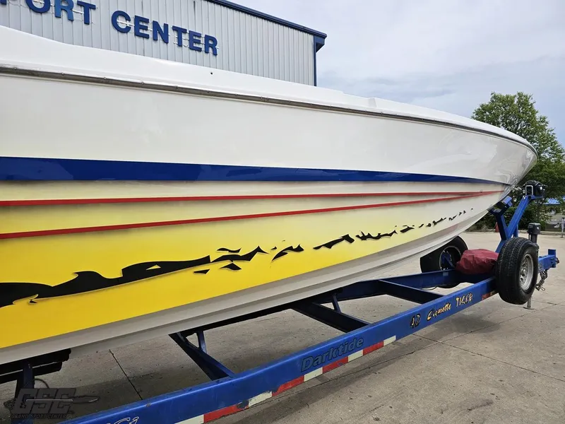 Slide: The Image of 2001 Cigarette 42 Tiger boat on trailer, featuring vibrant yellow and blue design. - 14