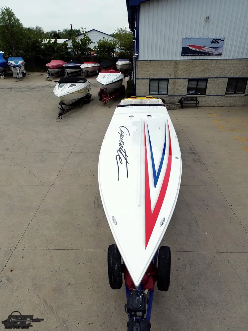 Slide: The Image of 2001 Cigarette 42 Tiger speedboat on trailer, parked outside a building with other boats. - 17