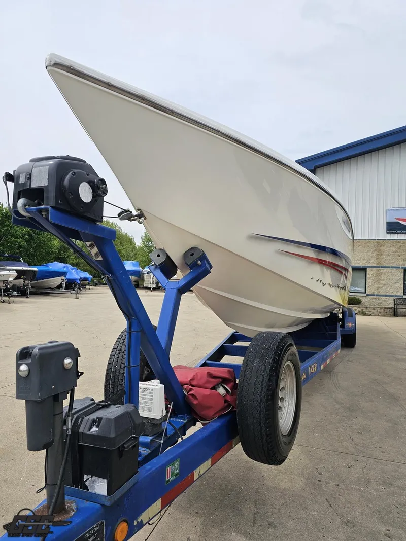 Slide: The Image of 2001 Cigarette 42 Tiger boat on trailer, parked outdoors near a building. - 20