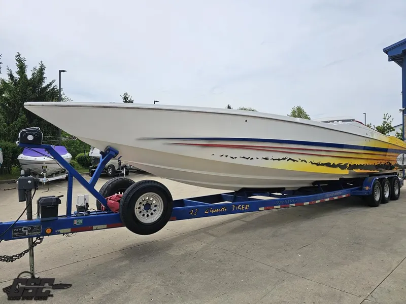 Slide: The Image of 2001 Cigarette 42 Tiger speedboat on trailer, featuring vibrant graphics and sleek design. - 21