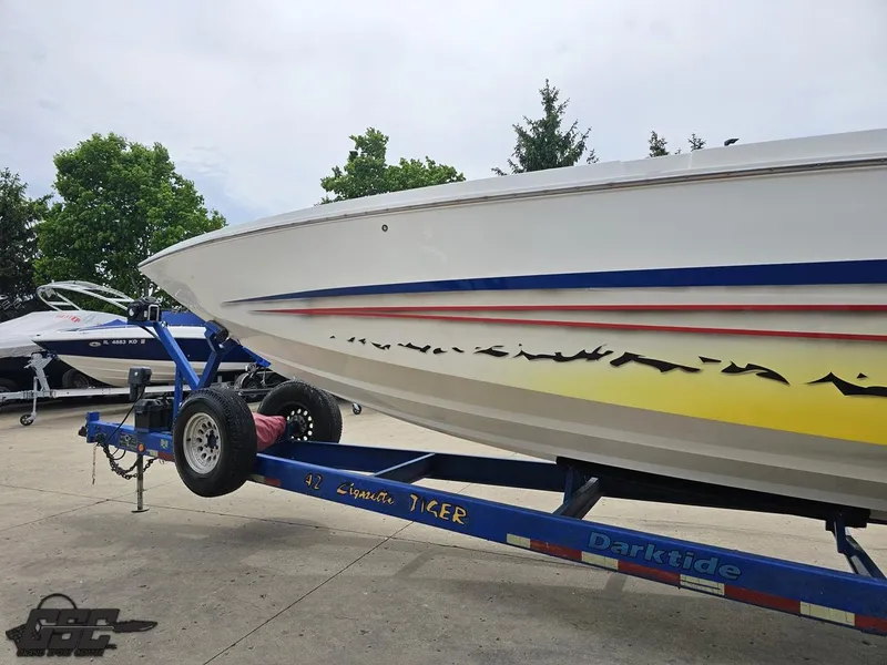 Slide: The Image of 2001 Cigarette 42 Tiger boat on trailer, featuring vibrant graphics and sleek design. - 24