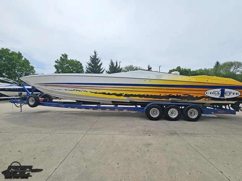 Slide: The Image of 2001 Cigarette 42 Tiger speedboat on trailer, featuring vibrant yellow and black graphics. - 27