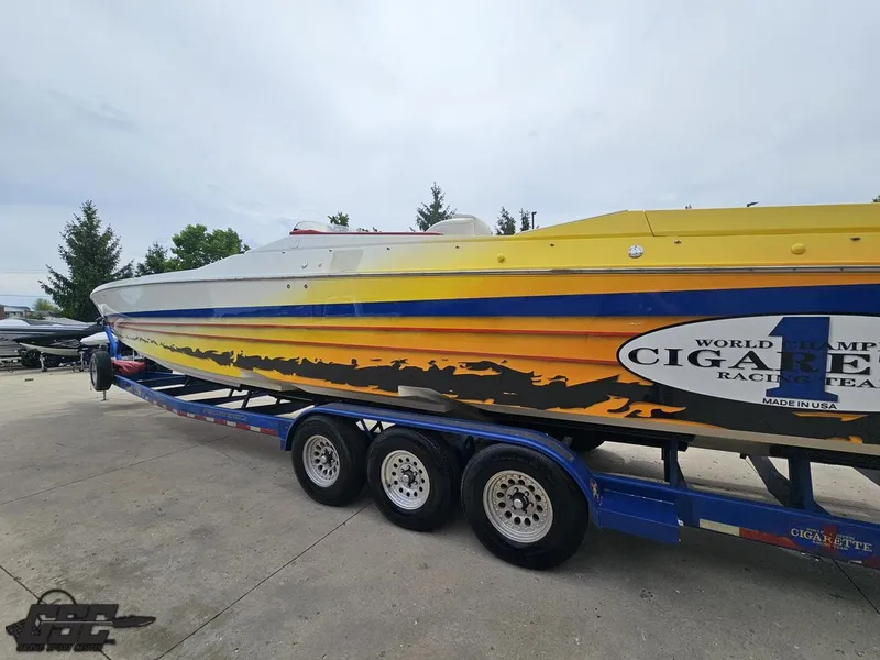 Slide: The Image of 2001 Cigarette 42 Tiger speedboat on trailer, vibrant yellow and blue design. - 29