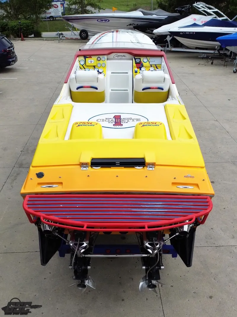 Slide: The Image of 2001 Cigarette 42 Tiger speedboat with vibrant yellow and red design, docked on concrete. - 33