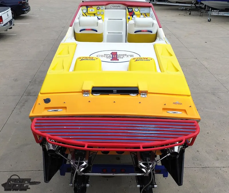 Slide: The Image of 2001 Cigarette 42 Tiger speedboat with vibrant yellow and orange design, docked on concrete. - 34
