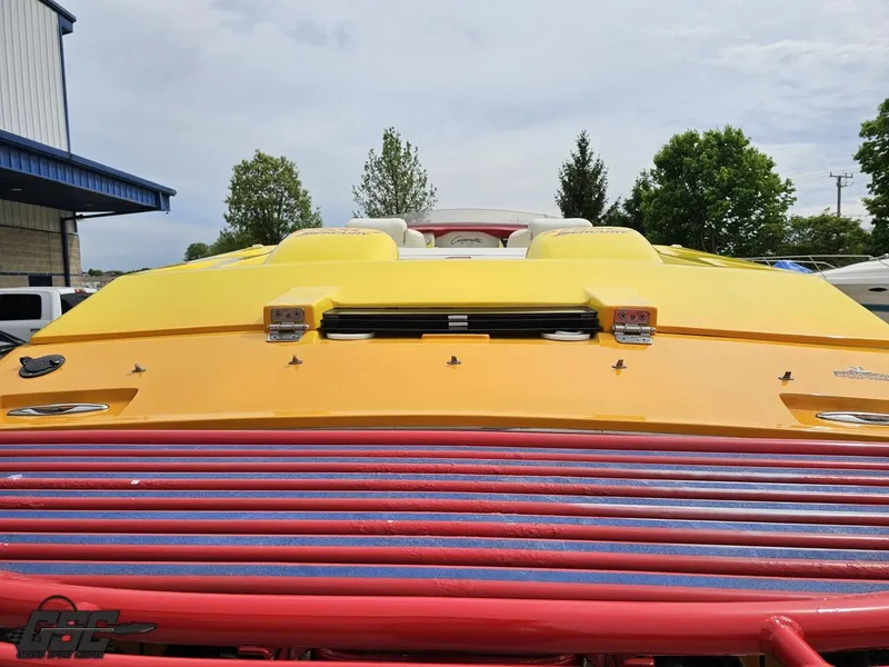 Slide: The Image of 2001 Cigarette 42 Tiger boat with vibrant yellow and red detailing, parked outdoors. - 35