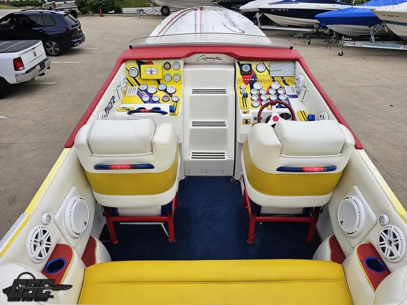 Slide: The Image of 2001 Cigarette 42 Tiger boat interior with vibrant yellow and red seating, dashboard, and controls. - 42
