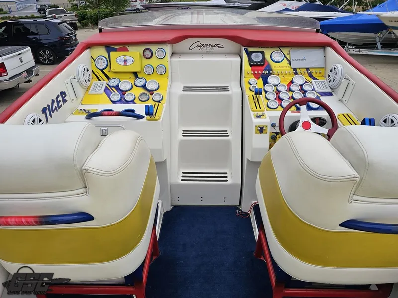 Slide: The Image of 2001 Cigarette 42 Tiger boat cockpit with vibrant yellow and white dashboard, dual seats. - 44