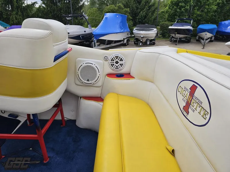 Slide: The Image of 2001 Cigarette 42 Tiger boat interior with yellow and white seating, speakers, and logo. - 47