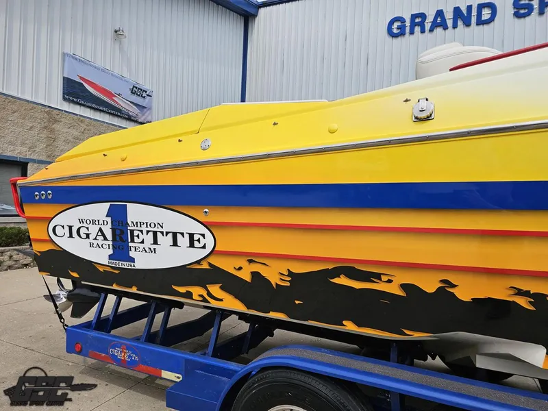 Slide: The Image of 2001 Cigarette 42 Tiger speedboat with vibrant yellow and blue design on trailer. - 8