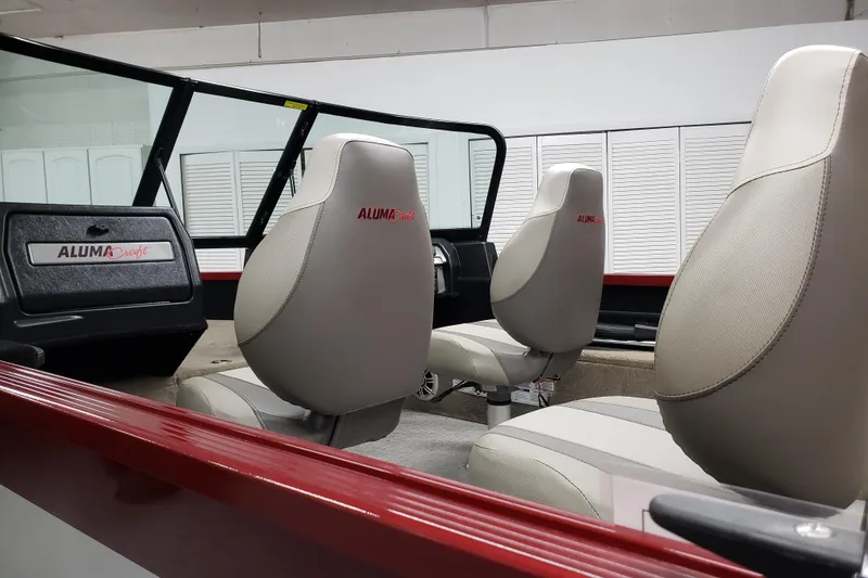 Slide: The Image of 2024 Alumacraft 165 SPT boat interior with beige seats and dashboard. - 7
