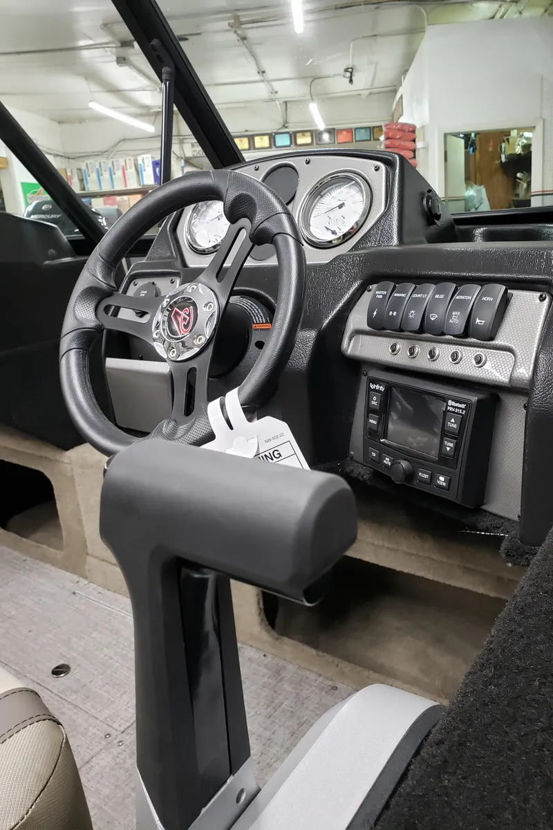 Slide: The Image of 2024 Alumacraft 165 SPT boat dashboard with steering wheel and control panel. - 8