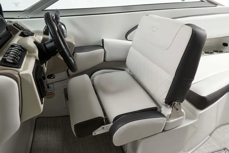 Slide: The Image of 2024 Crownline E305 boat interior with plush seating and modern steering console. - 10